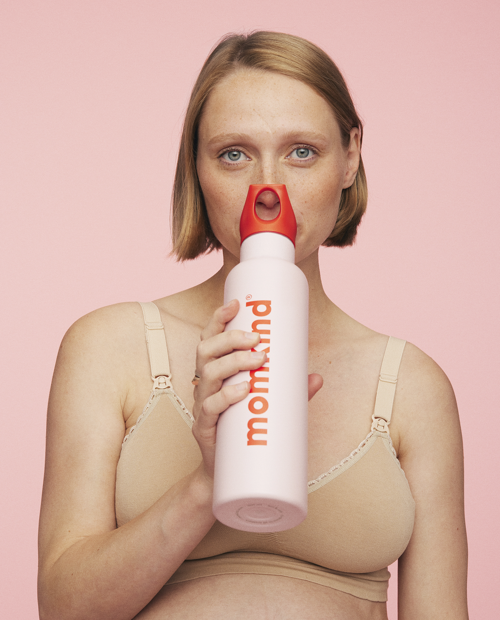 kvinde drikker af lyserød termo drikkedunk med sugerør fra momkind